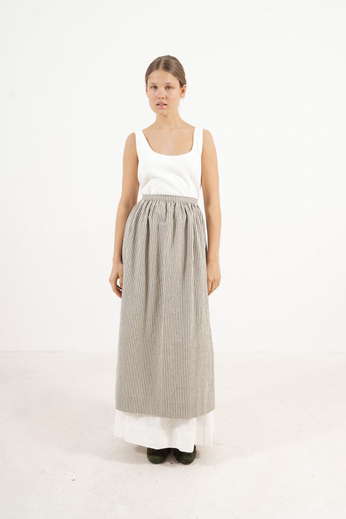 Le Tablier Striped Apron from the POÈME La Cuisine line by MOCHA, highlighting the clean silhouette and timeless woven stripe pattern in a front lookbook view.