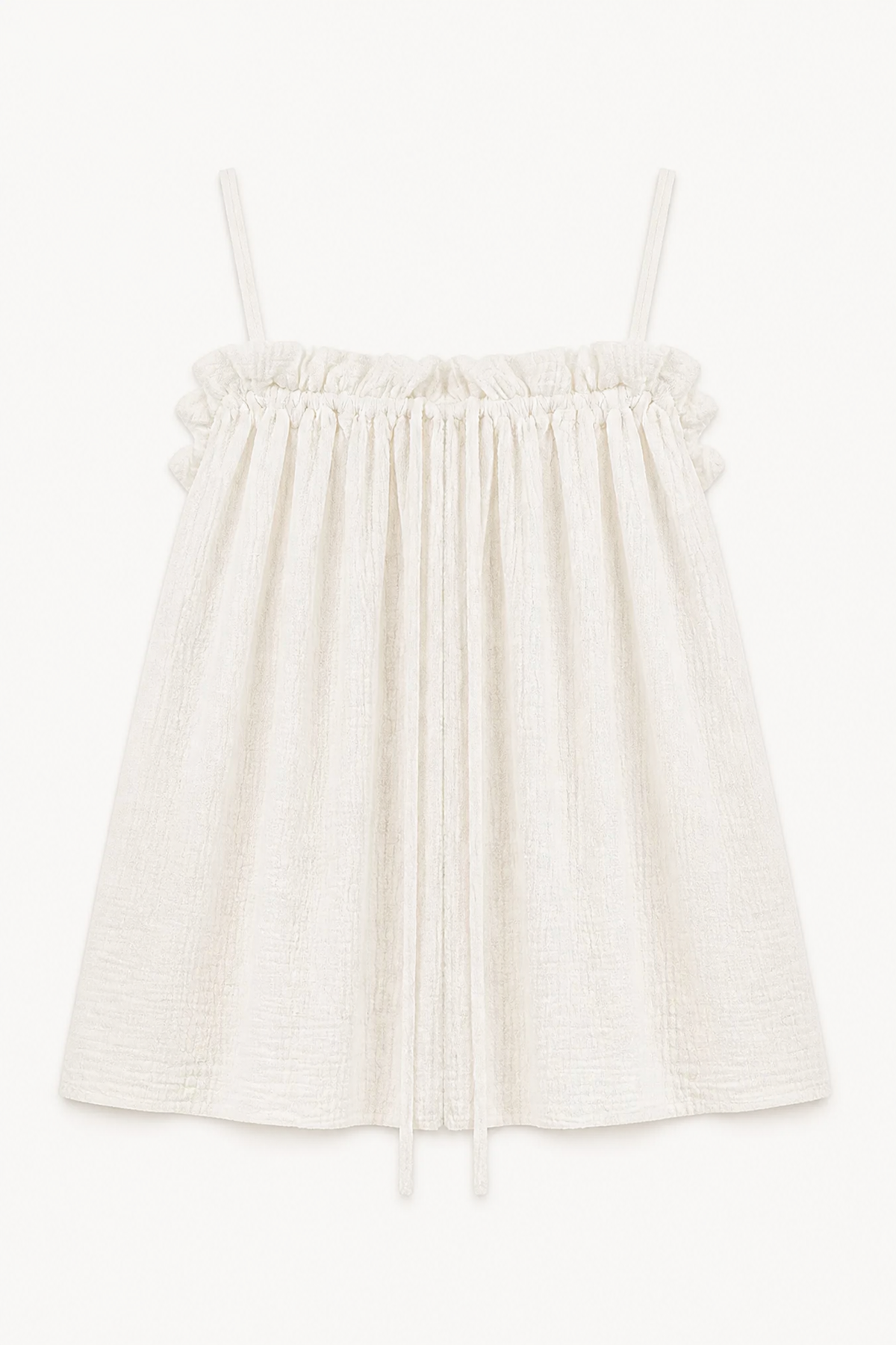 Minimalist flat lay layout of the MOCHA Adeline top, highlighting the organic cotton texture and voluminous silhouette.