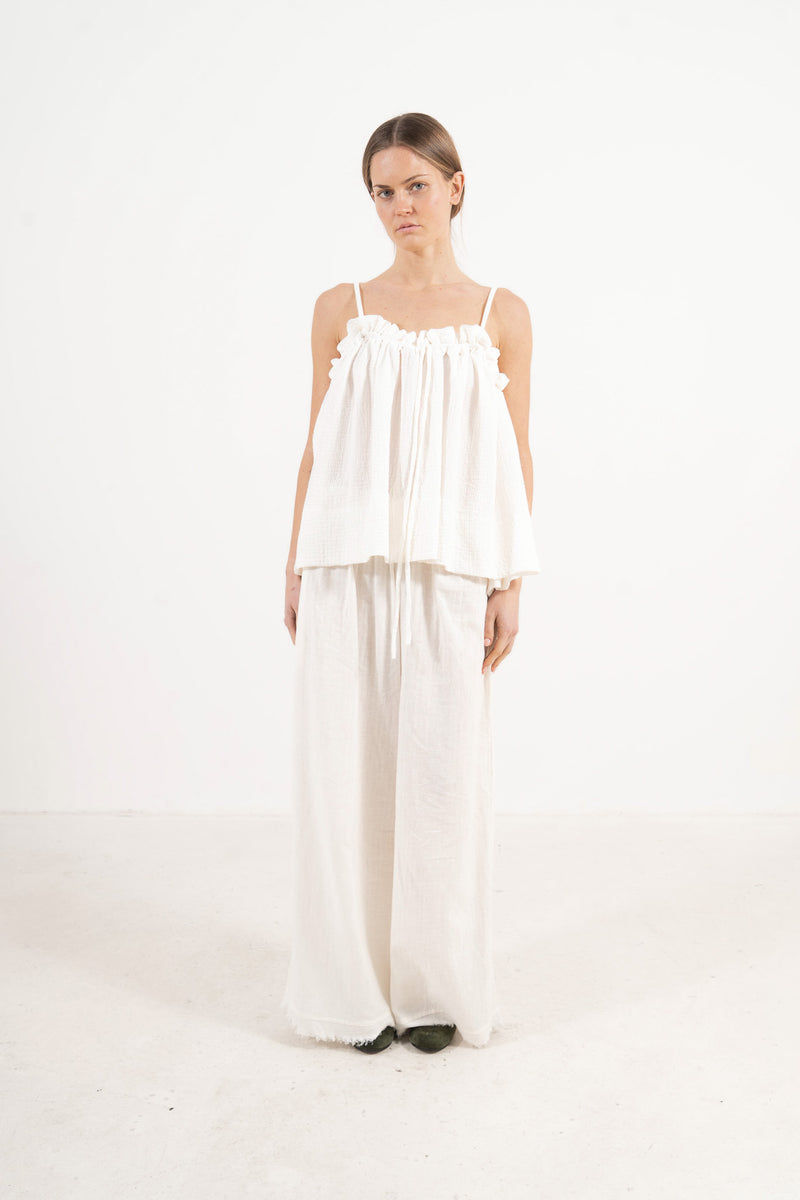 Front view studio portrait featuring a model in the solid Adeline top by MOCHA, capturing its quiet femininity and effortless elegance.