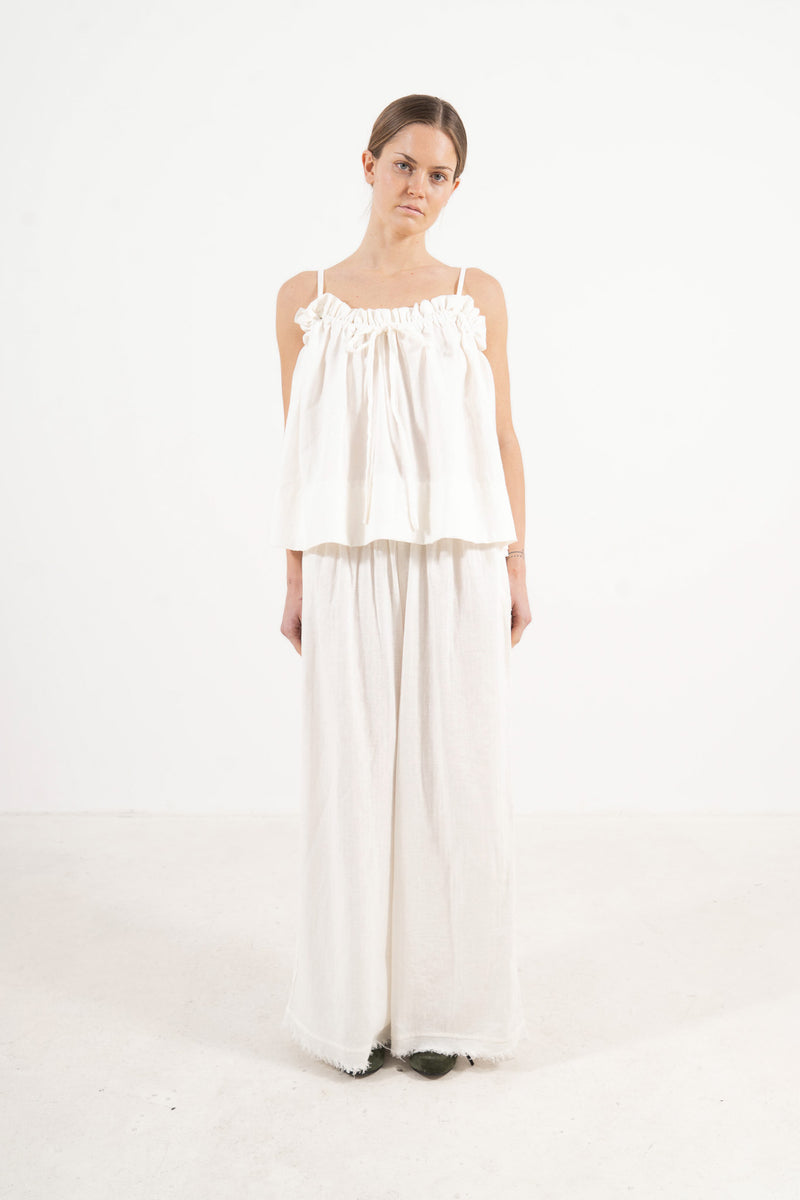 An elegant front view of the MOCHA Adeline top, meticulously crafted from the finest pure soft cotton and arranged beautifully upon a pristine white floor.