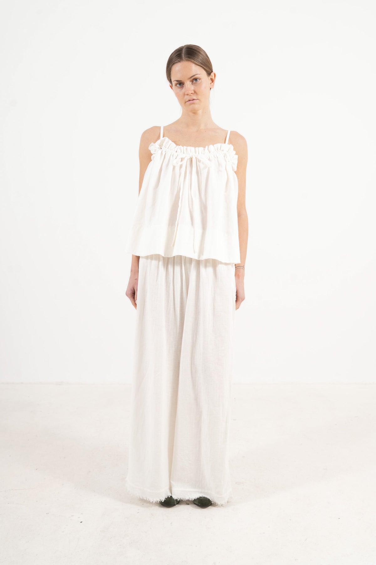 An elegant front view of the MOCHA Adeline top, meticulously crafted from the finest pure soft cotton and arranged beautifully upon a pristine white floor.
