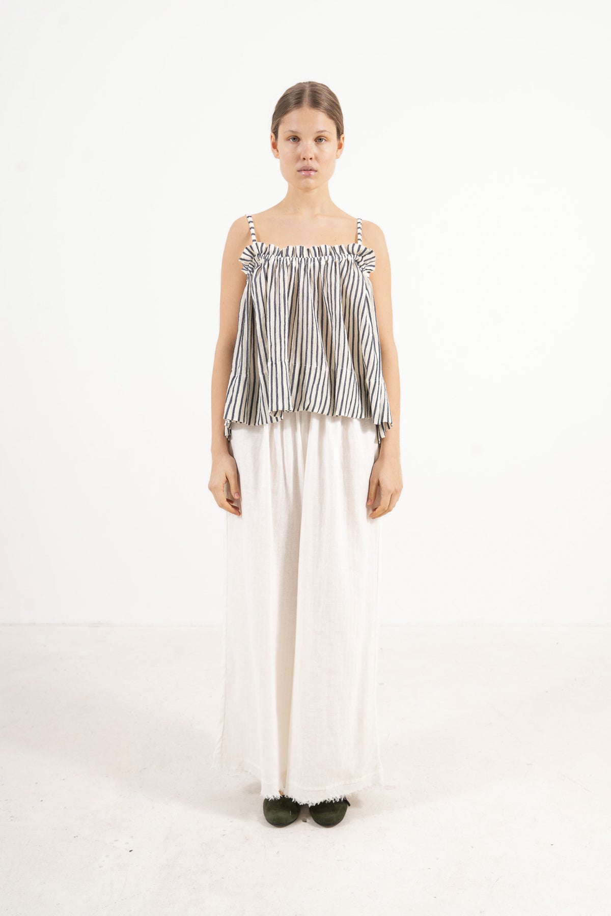 Front view studio portrait featuring a model in the striped Adeline top by MOCHA, capturing its quiet femininity and effortless elegance.