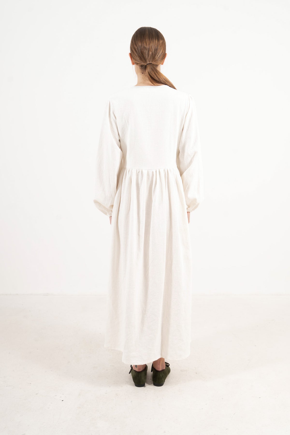 Woman wearing the Mocha Amadea cotton dress, back view