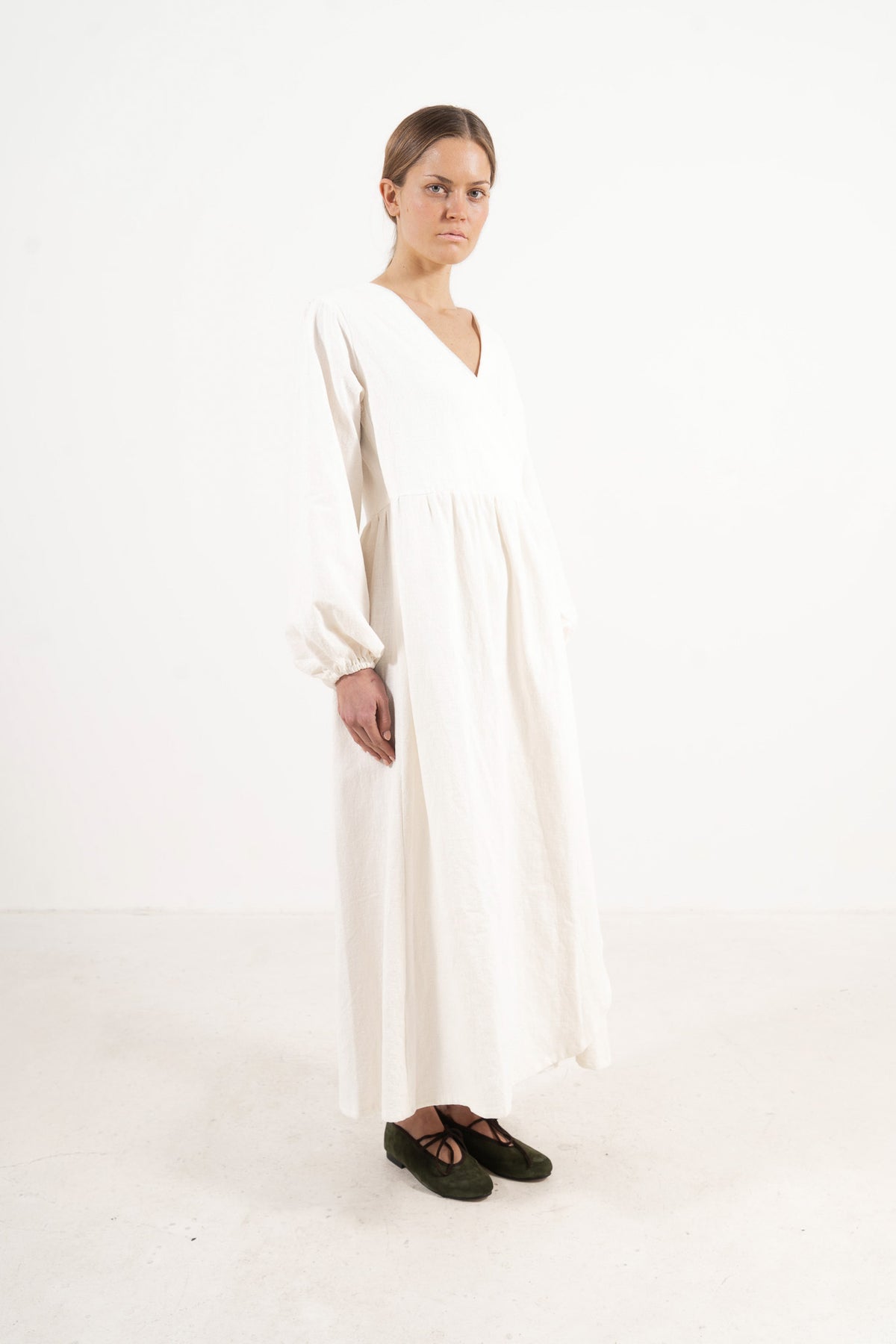 Woman wearing the Mocha Amadea cotton dress, side view