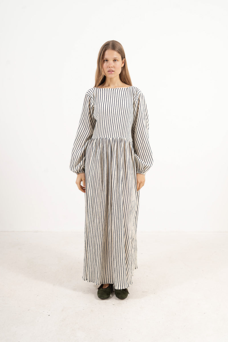 Front view studio portrait featuring a model in the striped Amadea long dress by MOCHA, capturing its effortless ease and airy elegance.