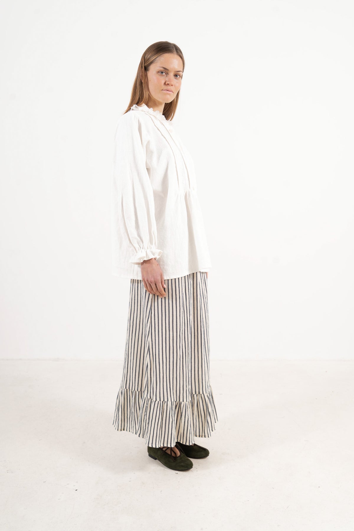 Side lookbook capture of the organic cotton blouse, emphasizing the beautiful movement of the long sleeves and flowing fabric.