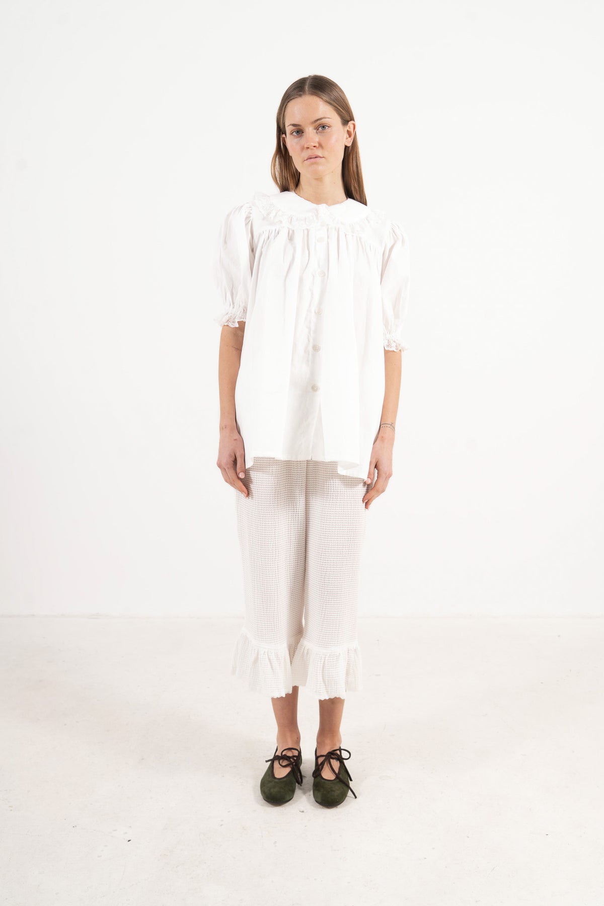 Front view studio portrait featuring a model in the Amour Blouse by MOCHA, wrapping you in effortless elegance and gentle lightness.