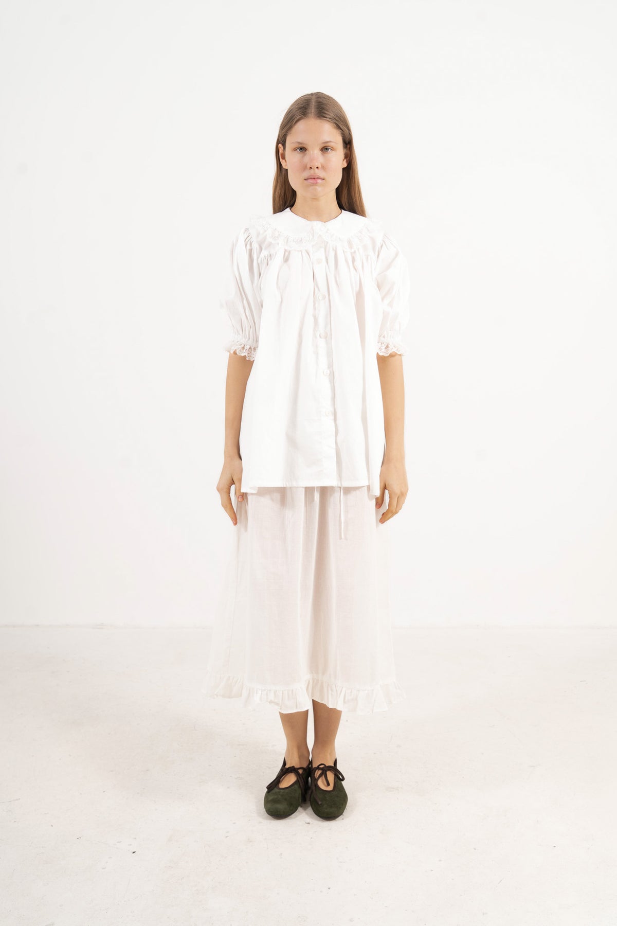 ront view studio portrait featuring a model in the Amour Blouse by MOCHA, wrapping you in effortless elegance and gentle lightness.