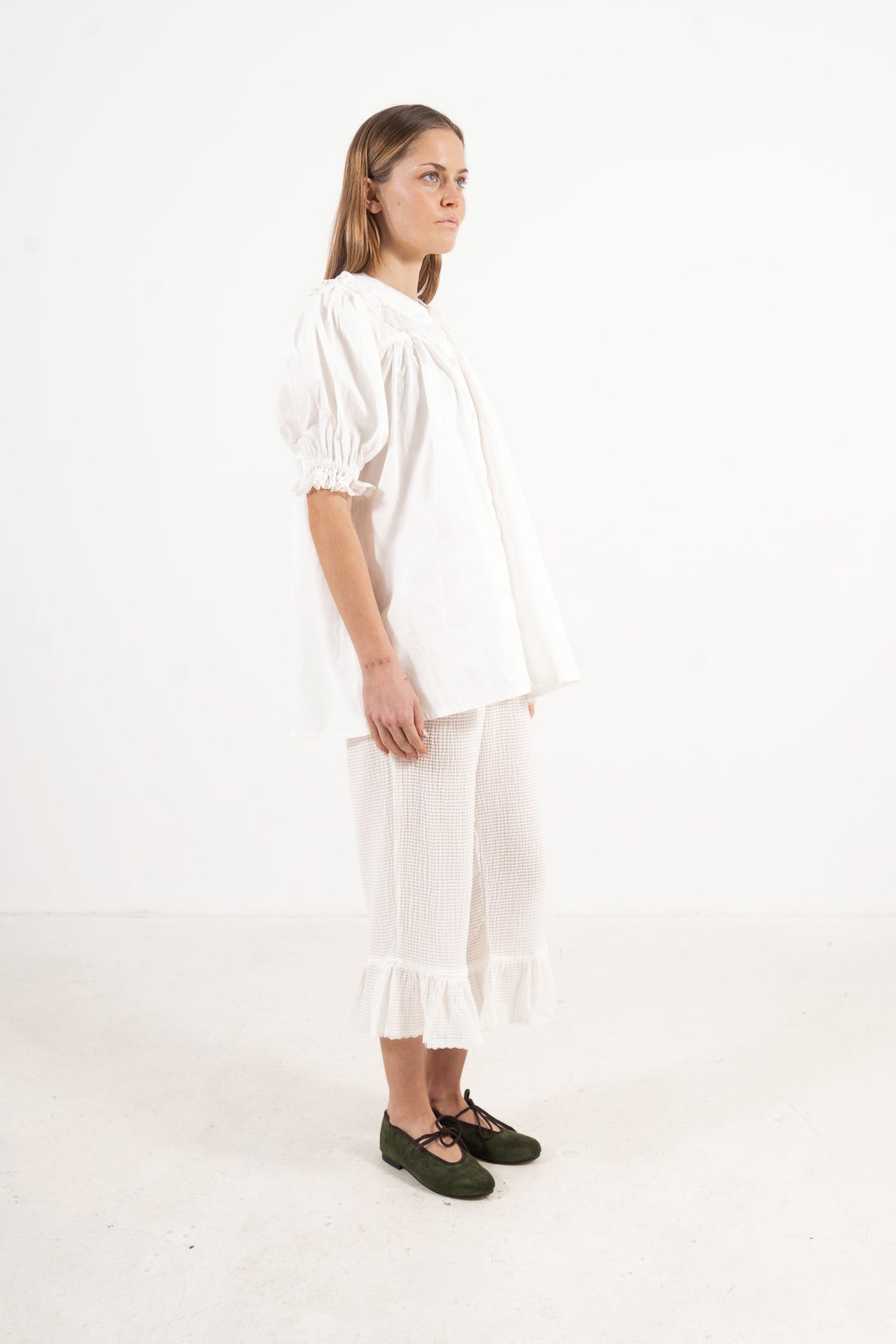 Side lookbook capture of the organic cotton blouse, emphasizing the beautiful movement of the long sleeves and flowing fabric.