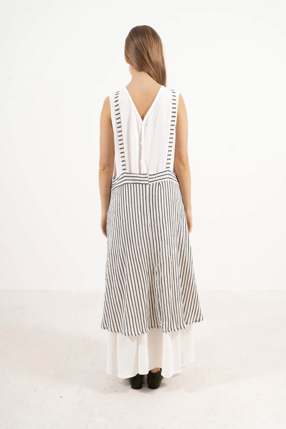 Back view of the MOCHA cotton apron skirt highlighting the rear strap design and clean waistband construction.