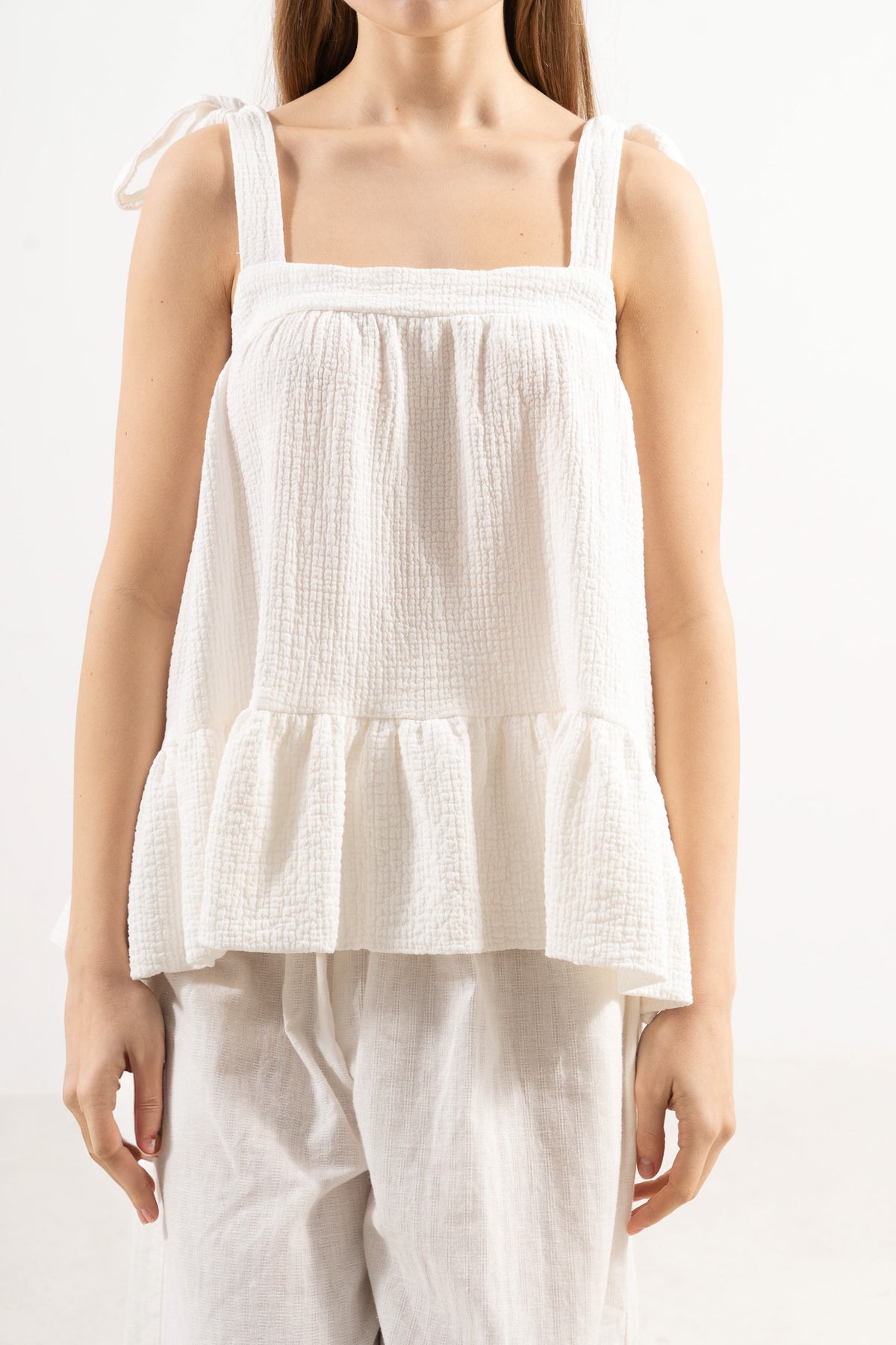 Close-up detail shot focusing on the delicate stitching, adjustable strap features, and premium weave of the MOCHA organic white cotton fabric.
