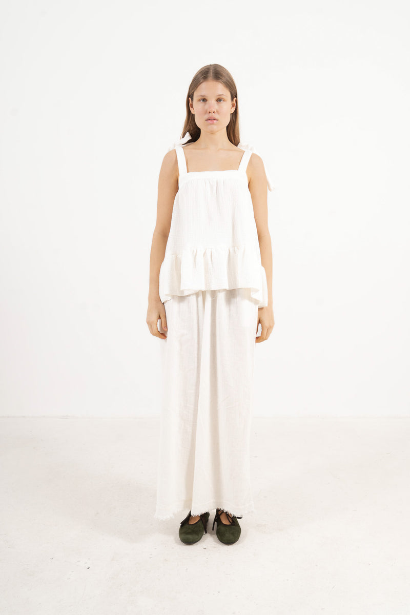 Front view studio portrait featuring a model in the white Belle top by MOCHA, capturing its subtle detailing and quiet femininity.
