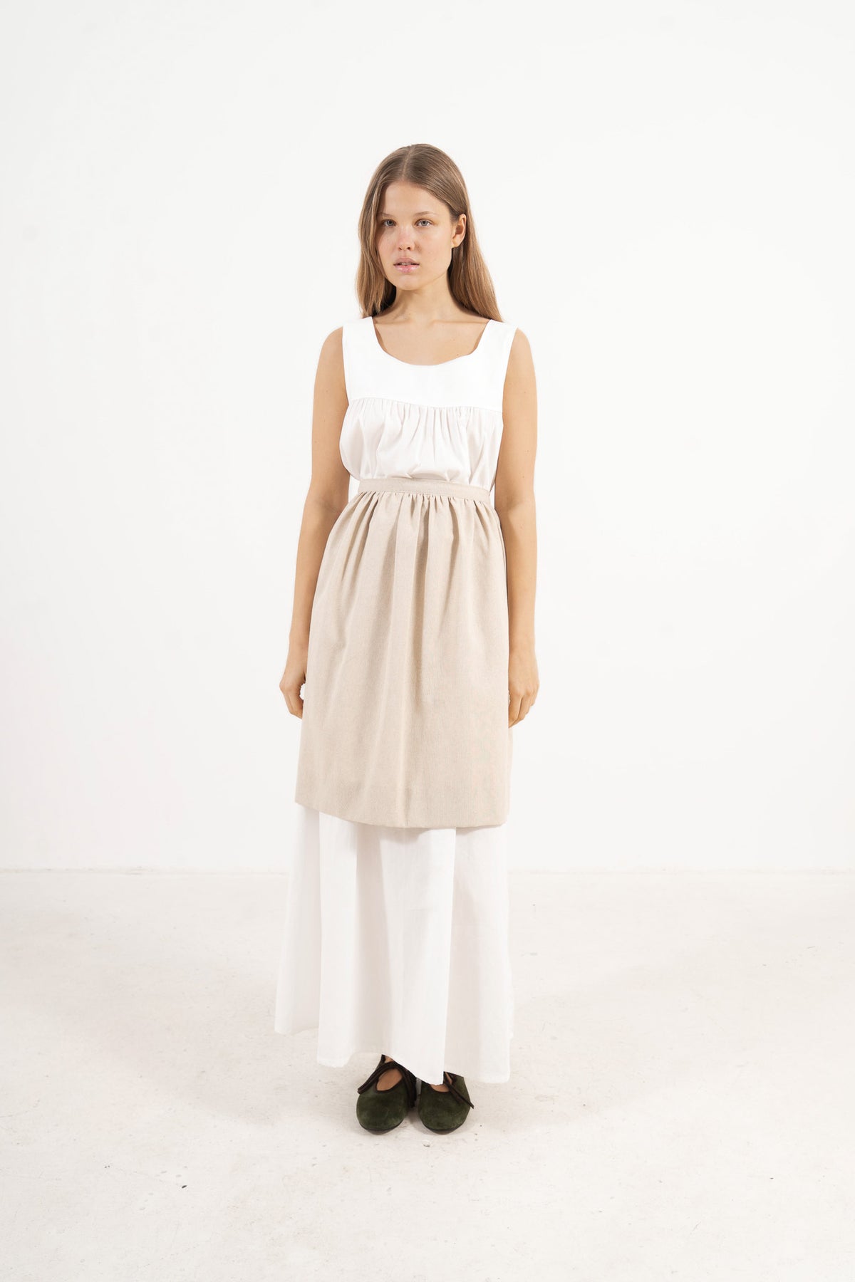 Side lookbook capture of the white cotton dress, emphasizing how the flowing fabric and generous length move easily with every step.