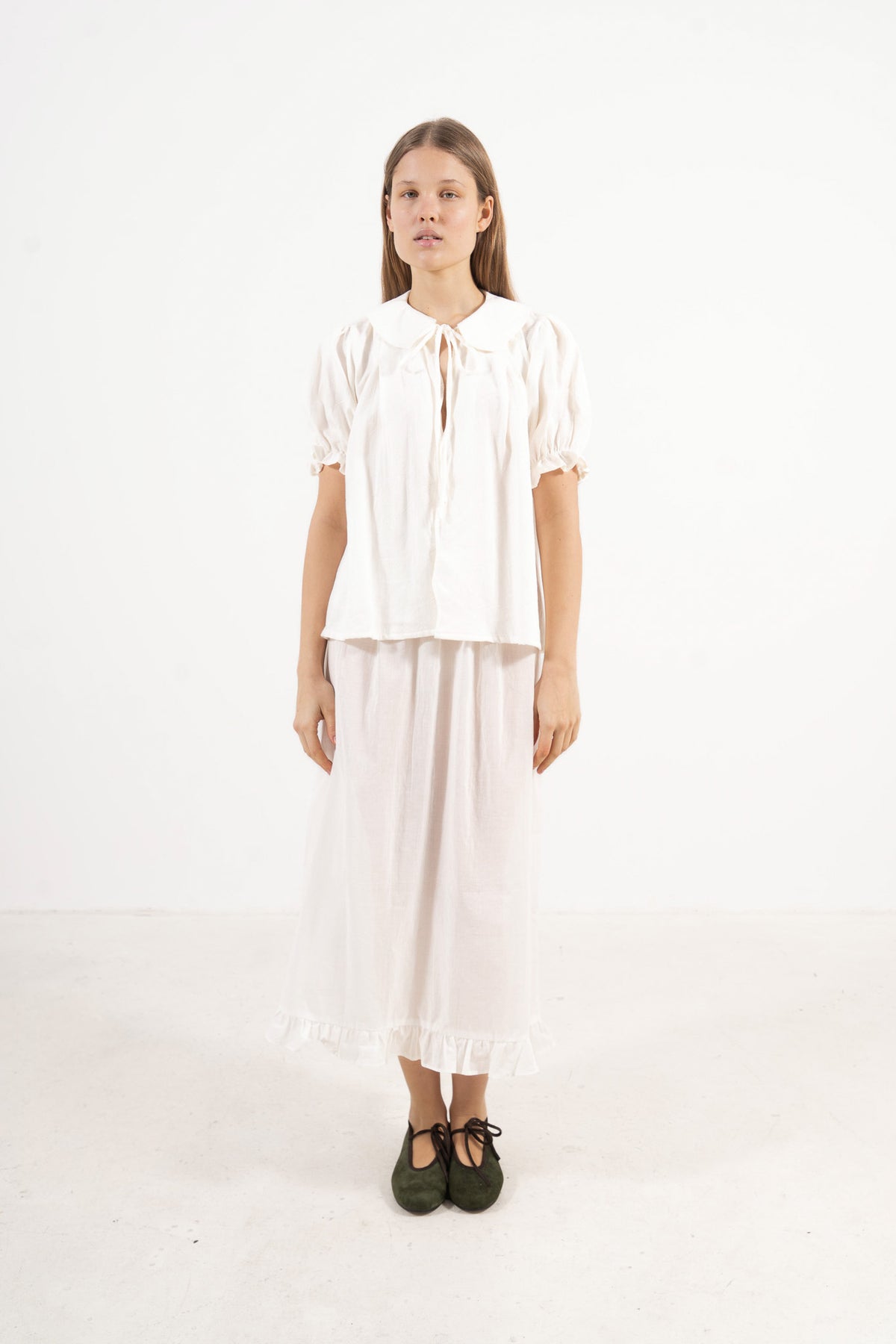 Front view studio portrait featuring a model in the Chérie Blouse by MOCHA, capturing its effortless elegance and charming romantic spirit.