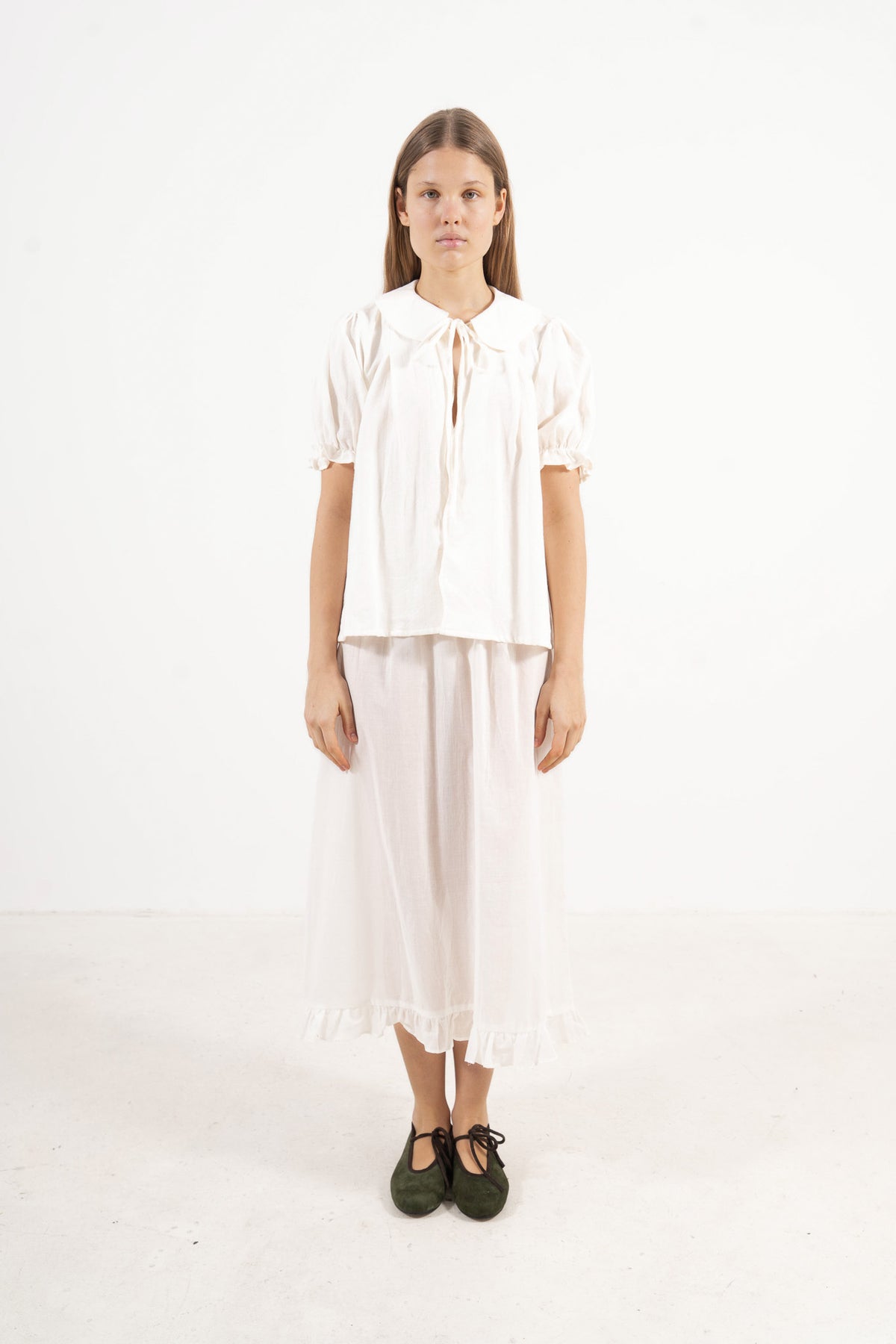 Front view studio portrait featuring a model in the Chérie Blouse by MOCHA, capturing its effortless elegance and charming romantic spirit.