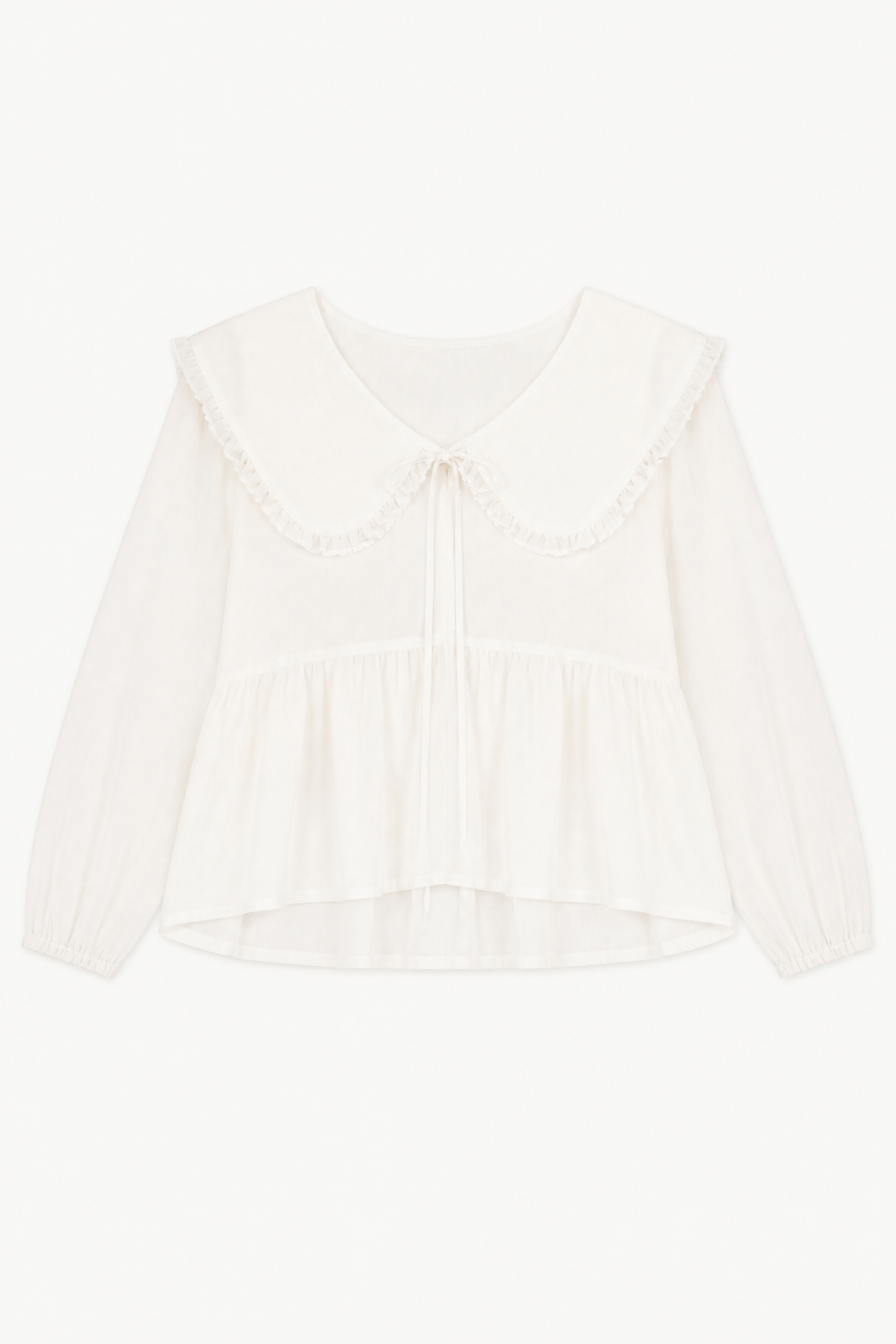 Minimalist flat lay layout of the MOCHA Élodie blouse, highlighting the crisp white organic cotton texture and its romantic, airy silhouette.