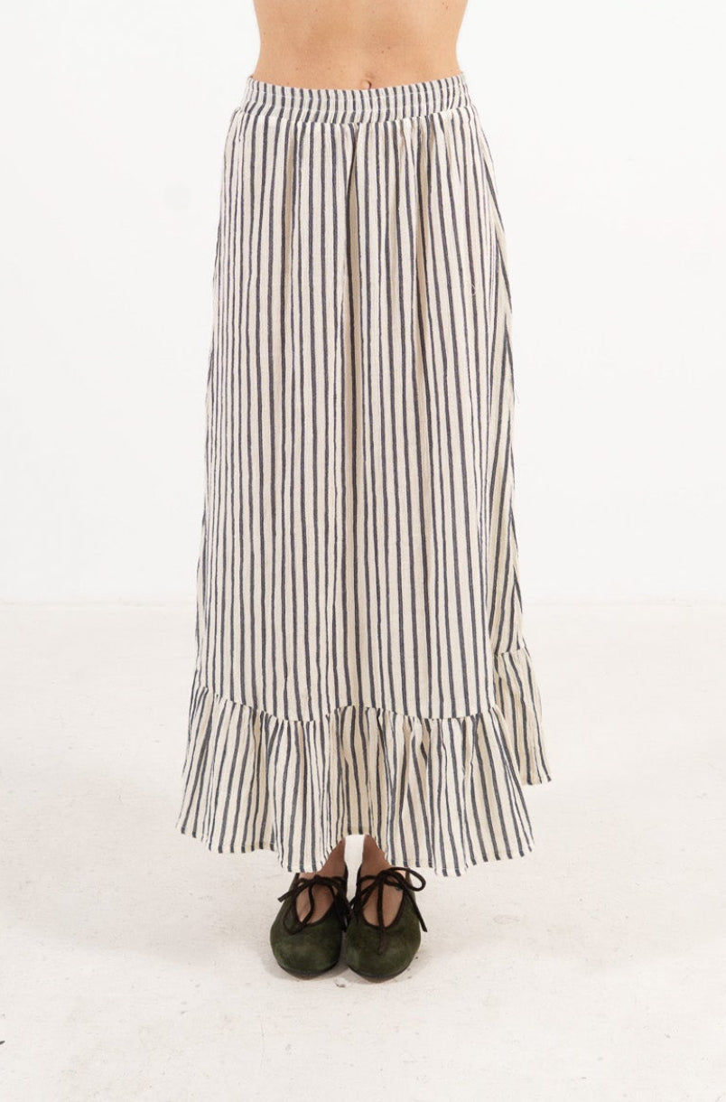 Front view studio portrait featuring a model in the striped organic cotton Élodie skirt by MOCHA, capturing its effortless elegance and flowing, graceful length.