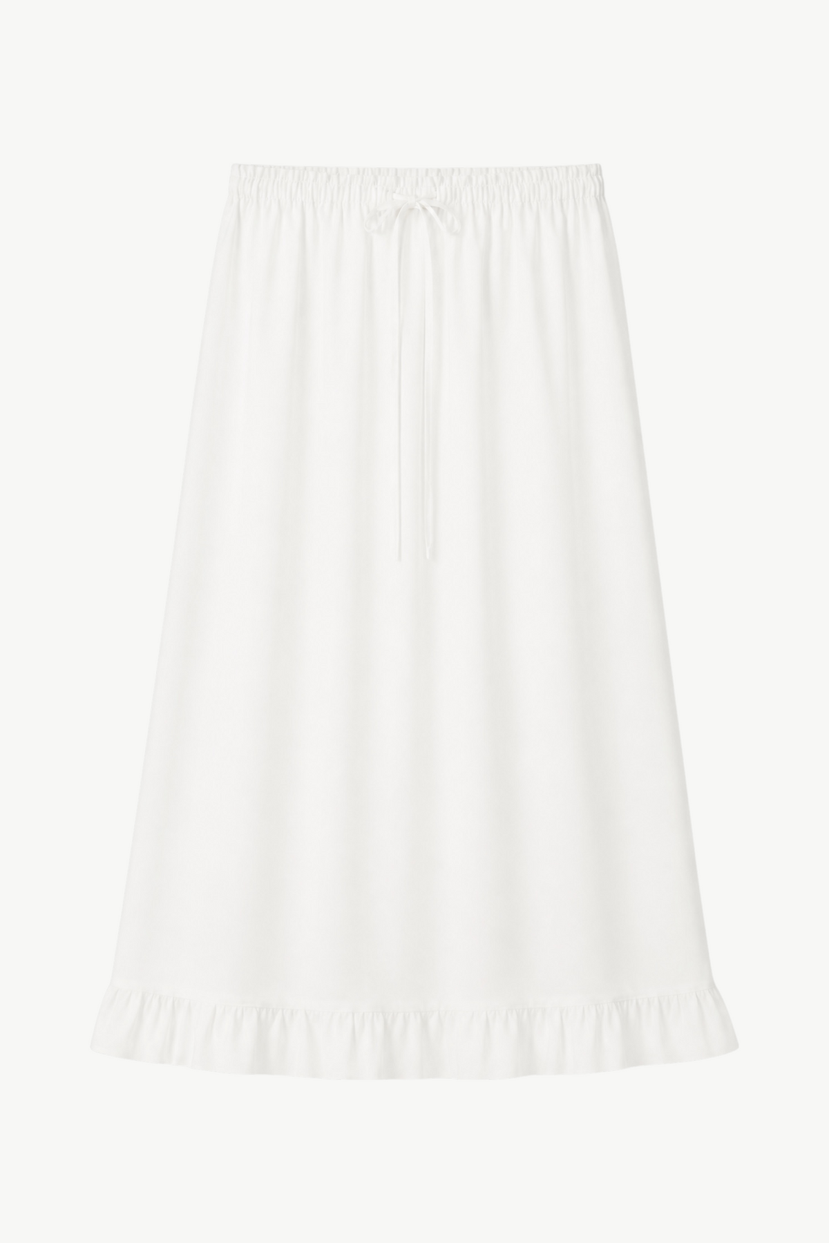 Minimalist flat lay layout of the MOCHA Élodie skirt, showcasing the airy, pure white organic cotton texture and its clean silhouette.
