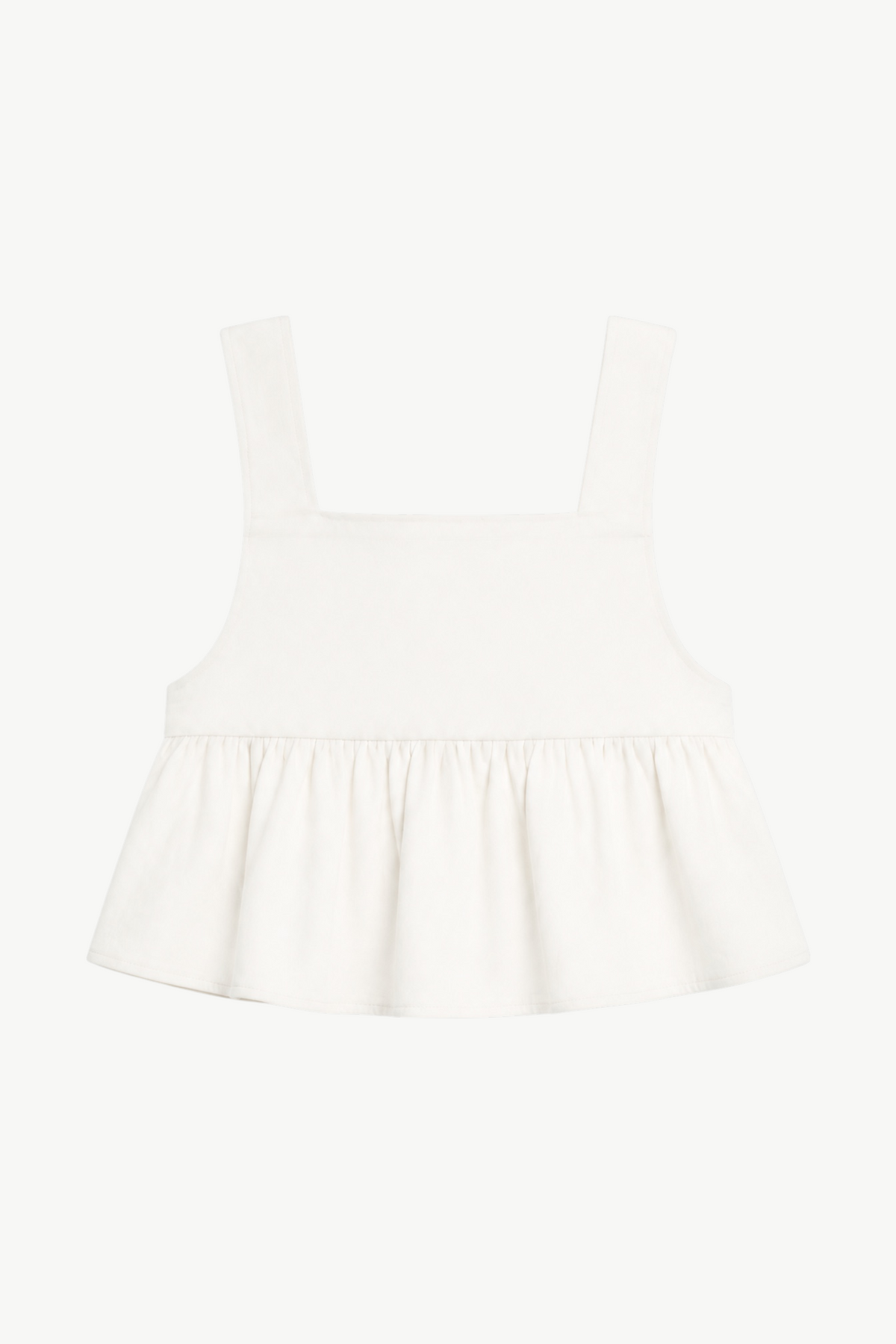 Minimalist flat lay layout of the MOCHA Jolie top, highlighting the soft organic cotton fabric and its pure, clean silhouette.