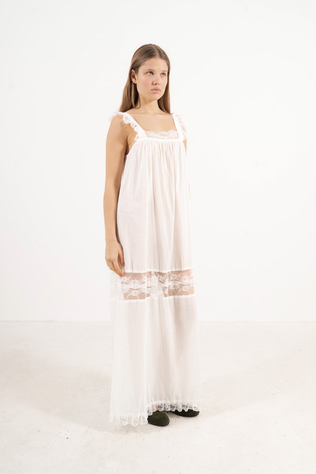 Studio profile shot showcasing the versatile fit, clean lines, and long silhouette of the MOCHA La Nuit dress