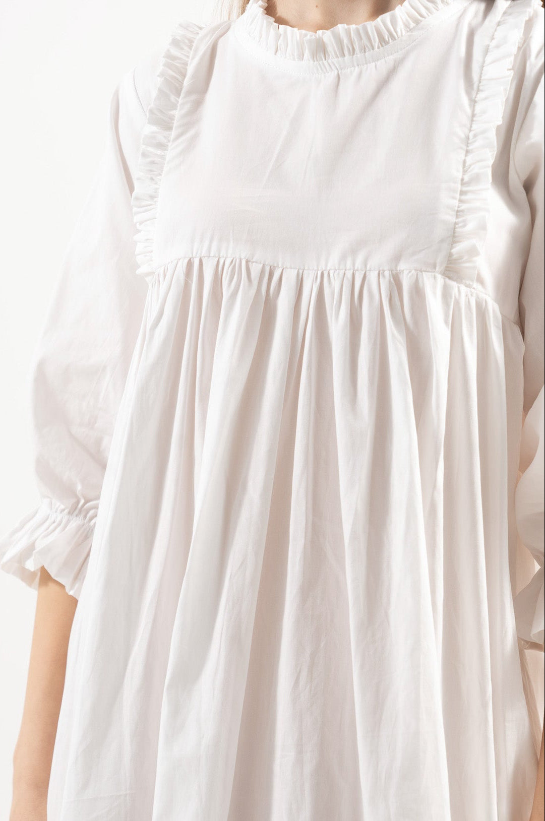 Close-up detail shot focusing on the intricate embellishments, delicate handwork, and majestic fabric textures of the MOCHA dress.