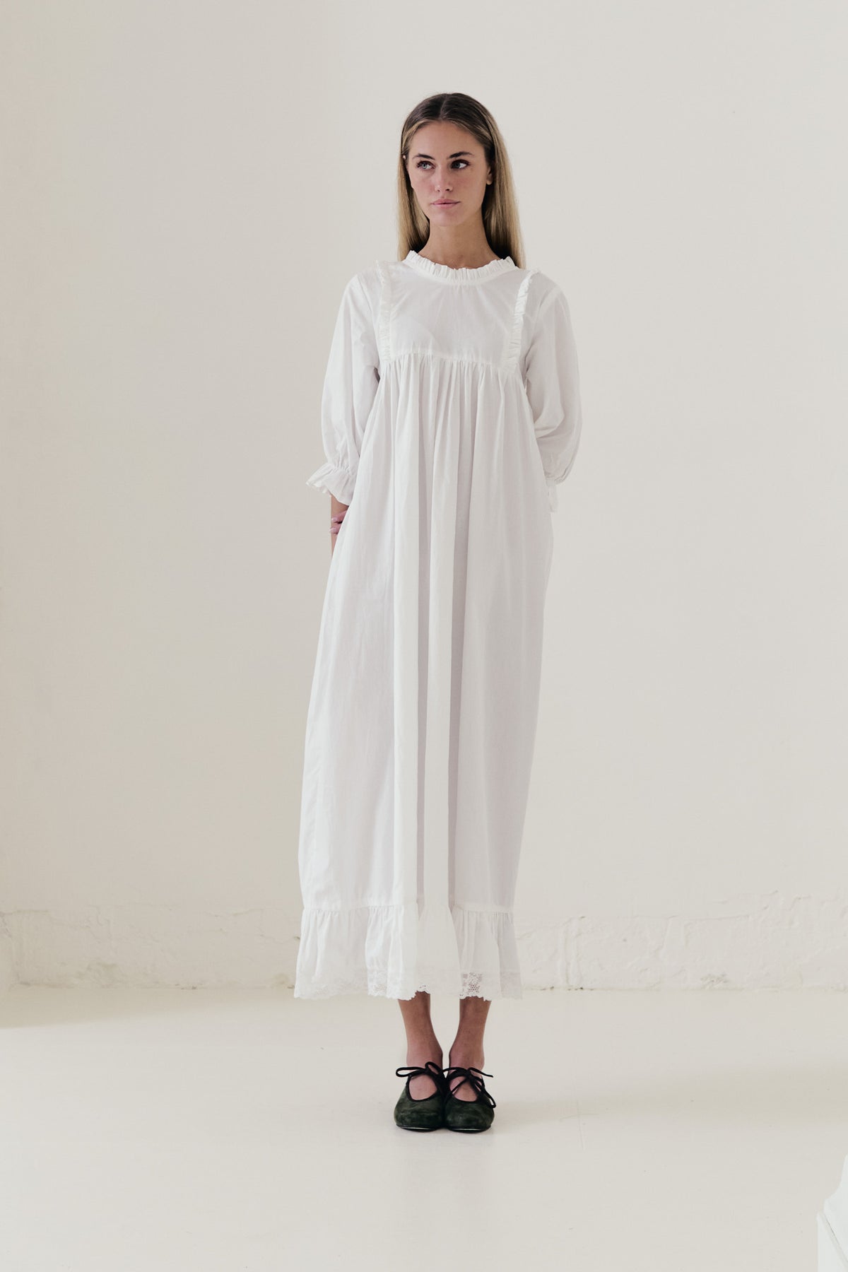 Front view studio portrait featuring a model in La Robe Noblesse by MOCHA, embodying aristocratic grace and understated opulence.