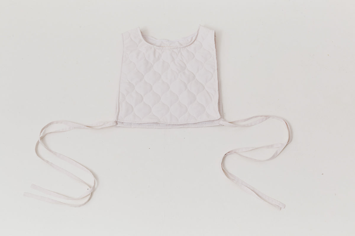 An elegant front view of the MOCHA Le Gilet de Poésie vest garment, meticulously crafted from the finest pure cotton and arranged beautifully upon a pristine white floor.