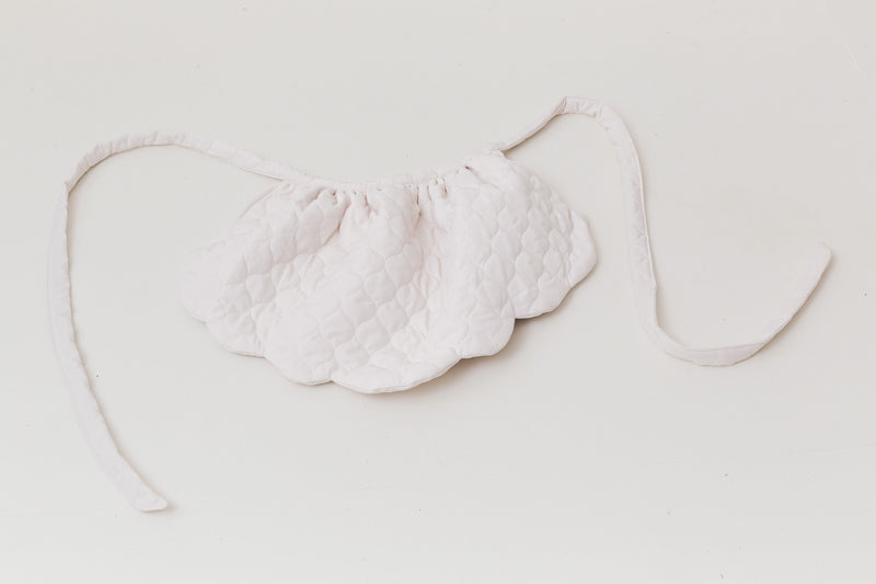 A luxurious flat layout of the MOCHA Le Petit Tablier de Poésie garment, capturing the exquisite drape of its pure cotton fabric and artistic, sophisticated tailoring layout.