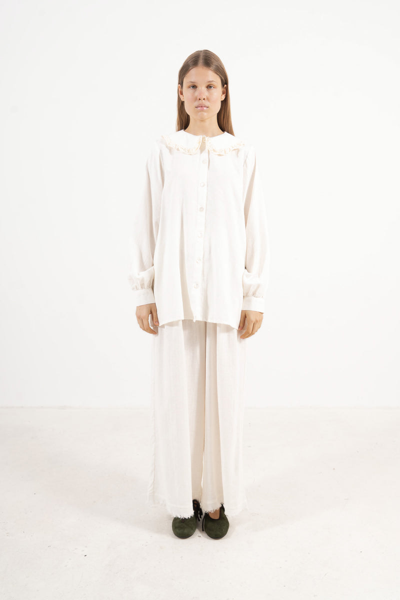 Front view studio portrait featuring a model in the Le Souffle Blouse by MOCHA, wrapping you in effortless elegance and gentle lightness.