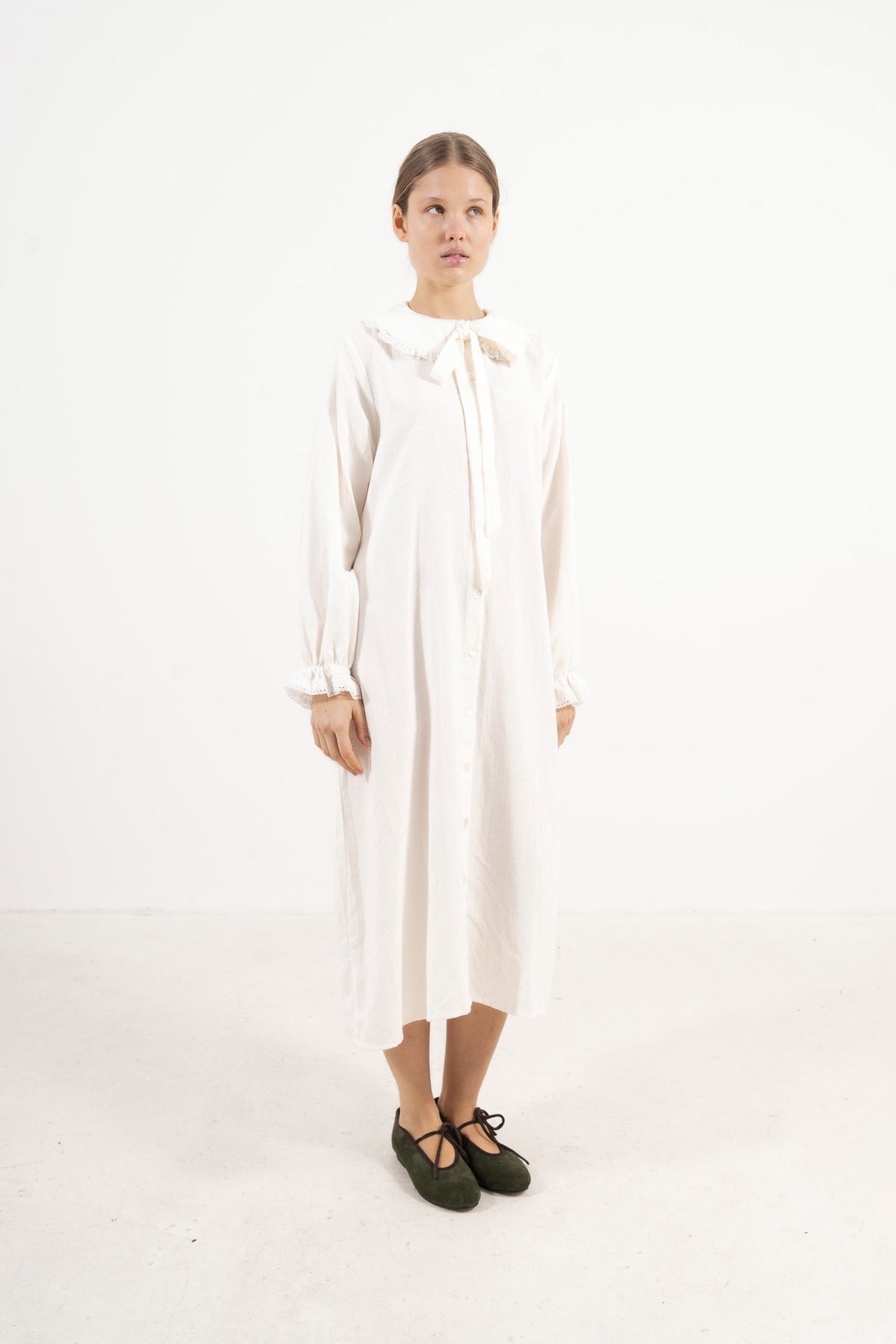 Studio lookbook capture highlighting the relaxed fit, pure structure, and graceful long sleeves of the MOCHA Le Souffle dress.