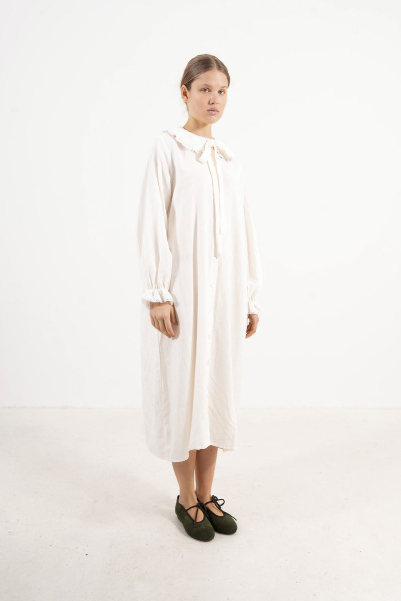 Studio lookbook capture highlighting the relaxed fit, pure structure, and graceful long sleeves of the MOCHA Le Souffle dress.