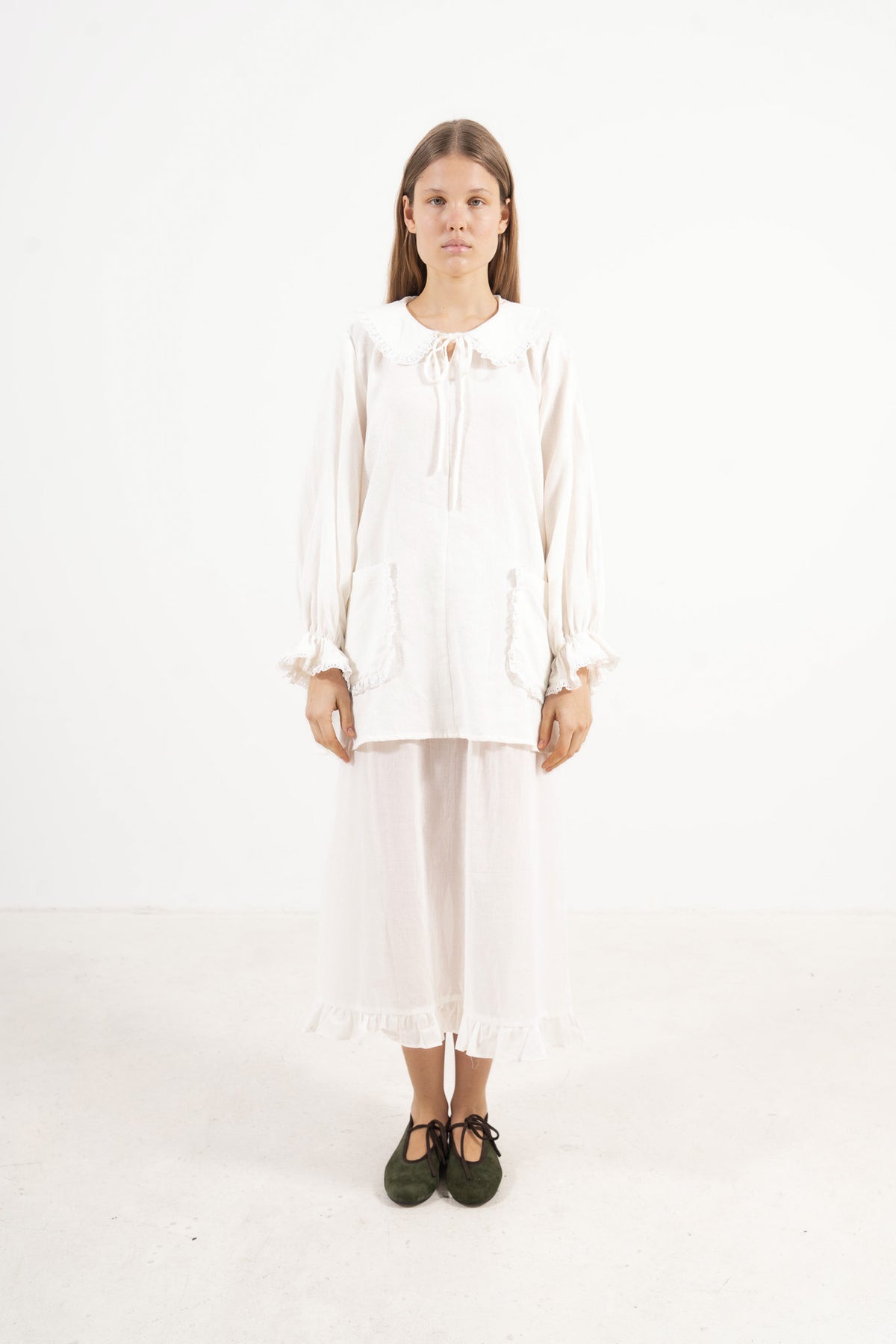 Front view studio portrait featuring a model in the Le Souffle tunique by MOCHA, wrapping you in effortless elegance and gentle lightness.