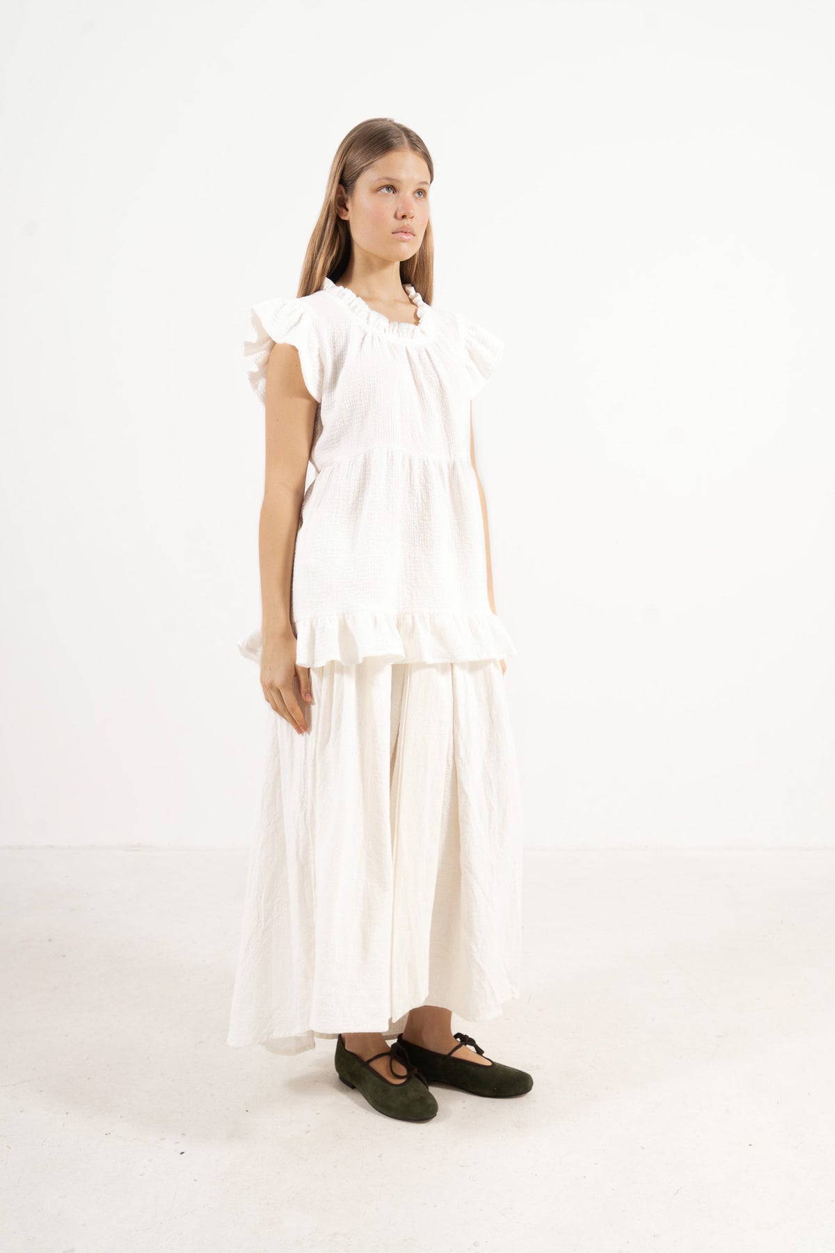 Side lookbook capture of the soft cotton top, emphasizing the beautiful, lightweight drape inspired by air, movement, and gentle days.