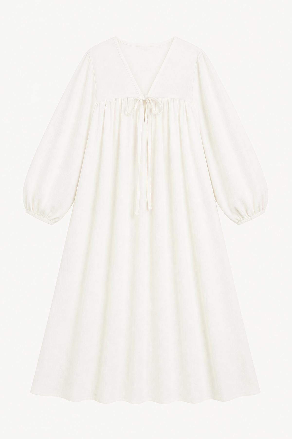 A luxurious flat close-up of the MOCHA Pearl Bow dress, capturing the soft, breathable texture of fine cotton and its delicate, feminine bow details