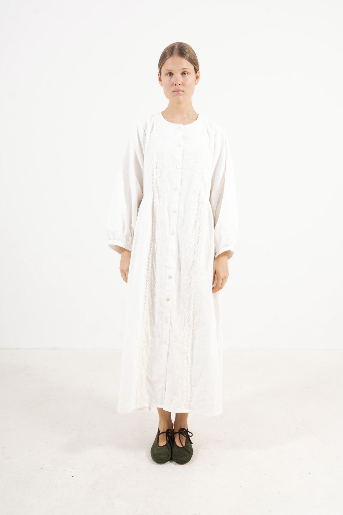 The Madeleine Dress from the POÈME La Clémence collection by MOCHA, showcasing an understated presence and gentle structure in a front view.