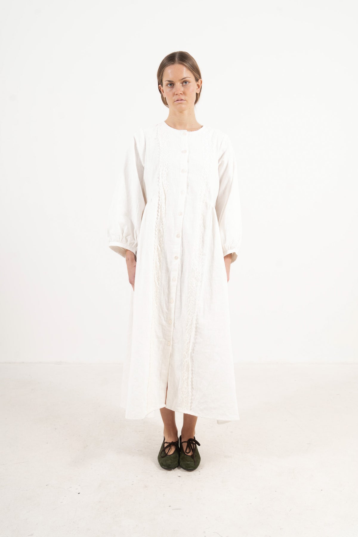 The Madeleine Dress from the POÈME La Clémence collection by MOCHA, showcasing an understated presence and gentle structure in a front view.