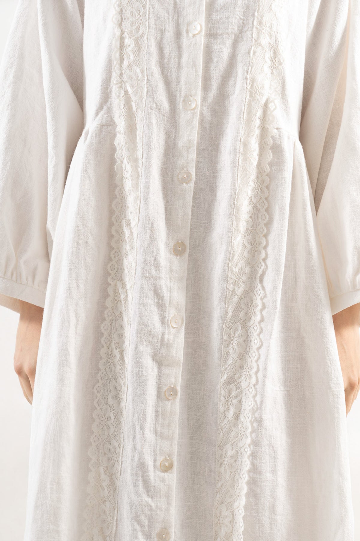 Detailed close-up focusing on the premium, refined fabric weave and elegant textures of the MOCHA Madeleine Dress.