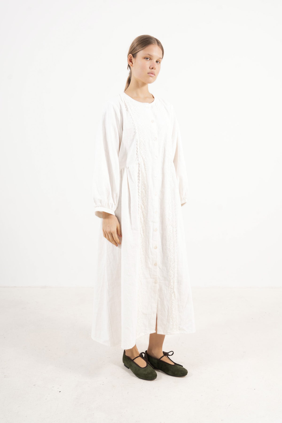 Editorial lookbook capture of the Madeleine Dress, embodying a study of softened elegance and quiet luxury.