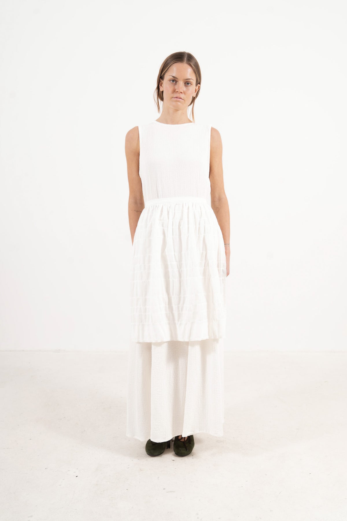 Le Tablier Mid Apron from the POÈME La Cuisine line by MOCHA, highlighting the clean silhouette and delicate volants in a front lookbook view.