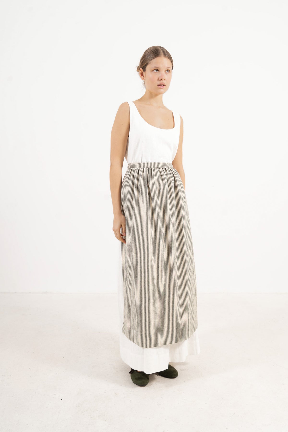 Le Tablier Striped Apron from the POÈME La Cuisine line by MOCHA, highlighting the clean silhouette and timeless woven stripe pattern in a front lookbook view.
