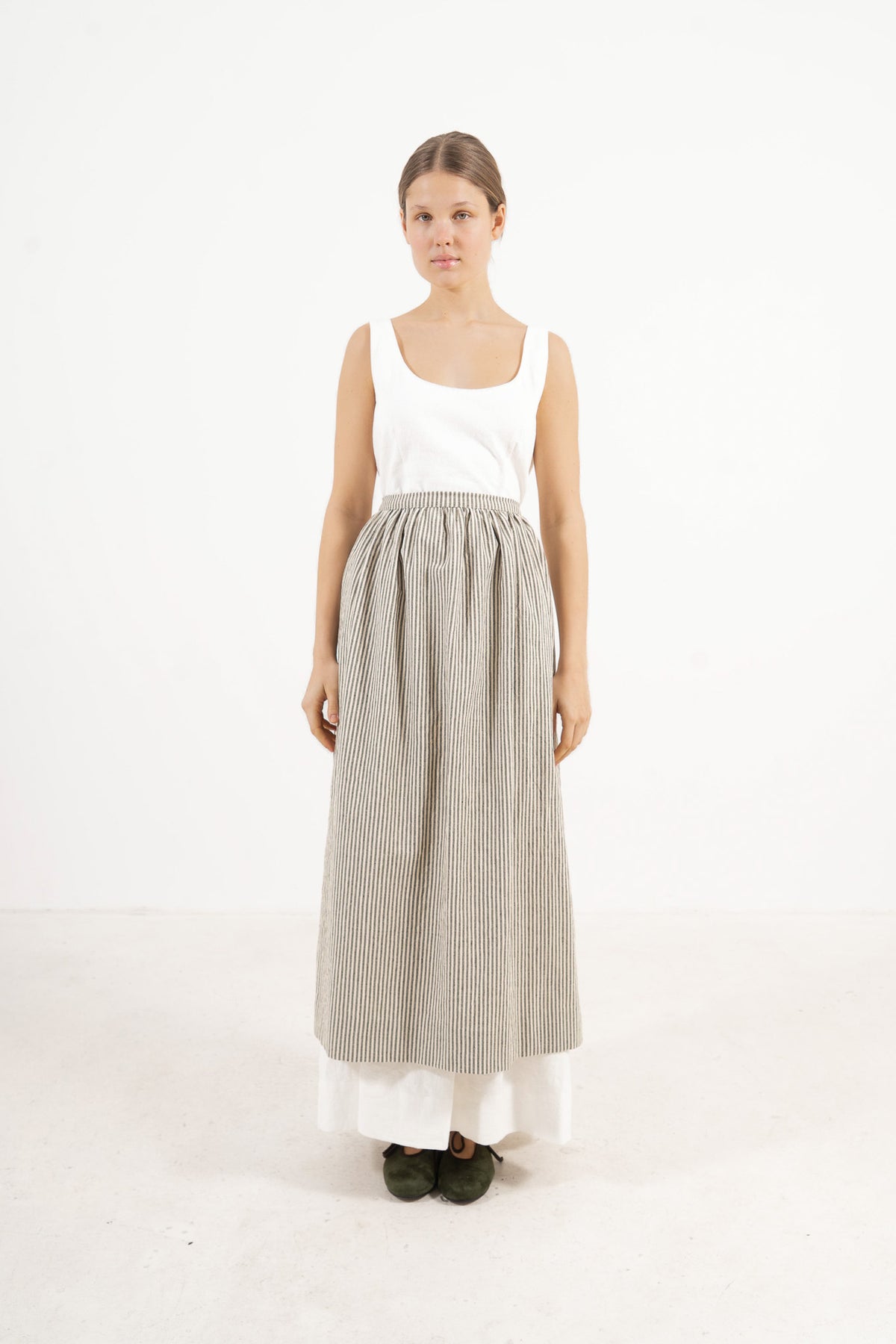 Le Tablier Striped Apron from the POÈME La Cuisine line by MOCHA, highlighting the clean silhouette and timeless woven stripe pattern in a front lookbook view.
