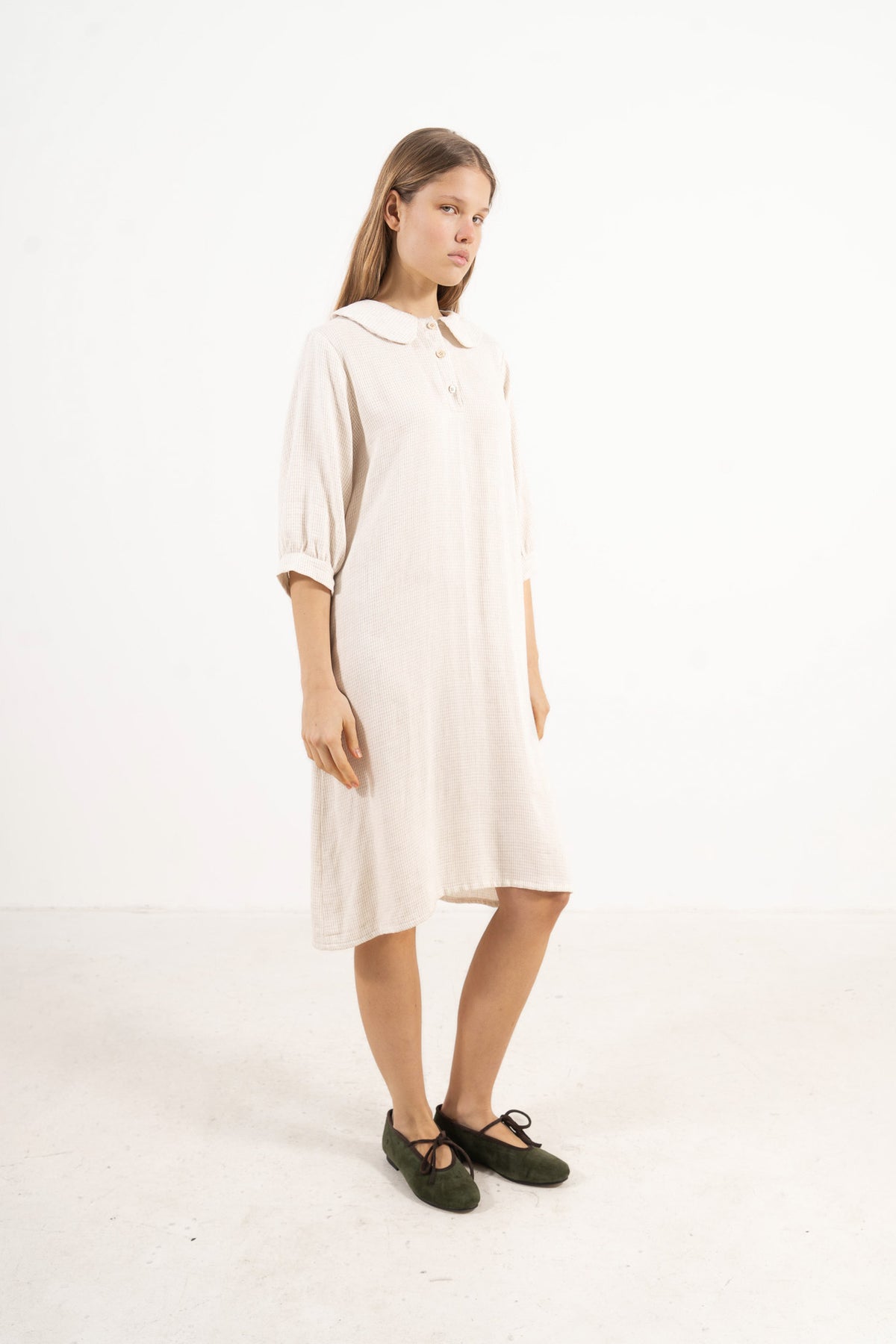 Side profile view of the Mielle Sleeve Dress, capturing the soft movement, sleeve structure, and understated femininity signature to MOCHA.