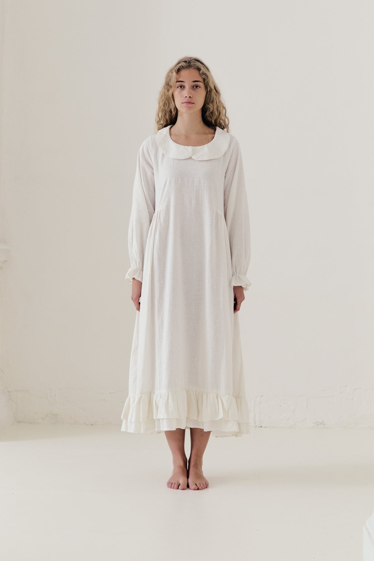 Front view studio portrait featuring a model in the Sillage Dress by MOCHA, capturing its effortless elegance and soft world of lightness.