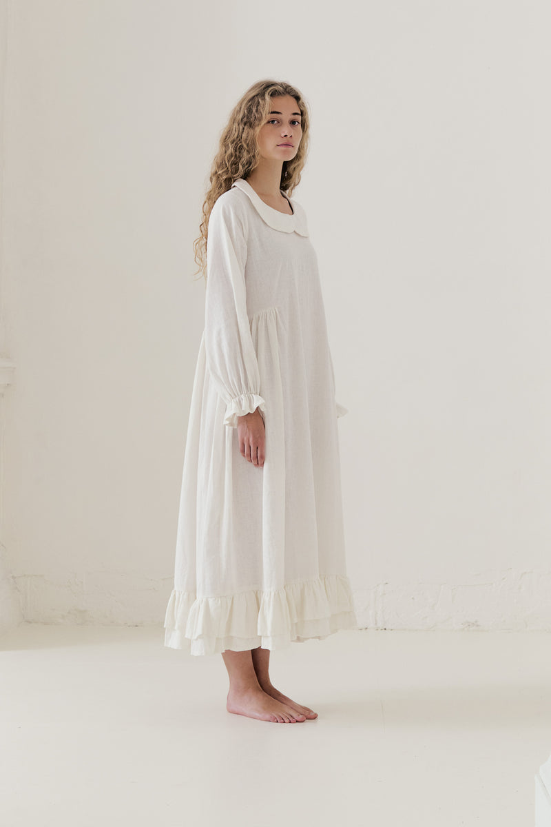 Side lookbook capture of the white cotton dress, emphasizing how the flowing fabric moves easily with every step.