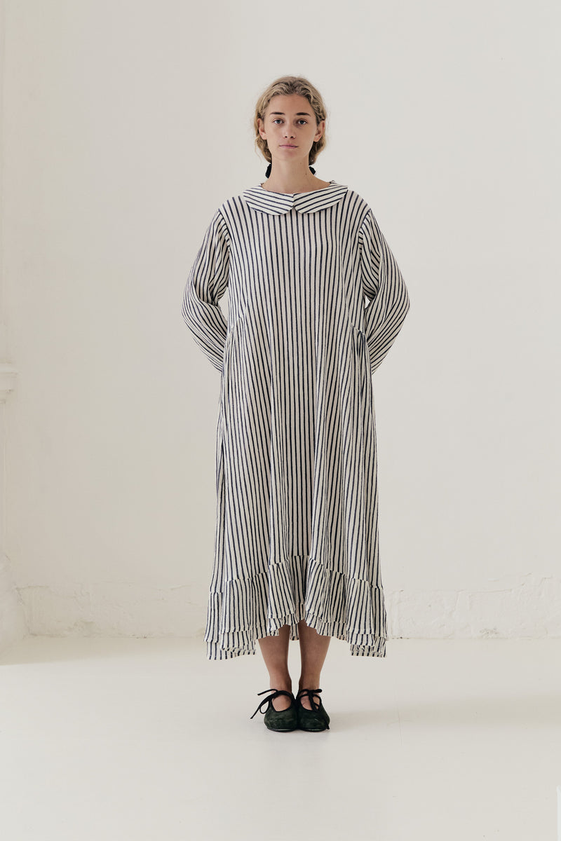 Bright, sunlit editorial lookbook capture of the striped Sillage dress, floating gracefully with an effortless sense of lightness.