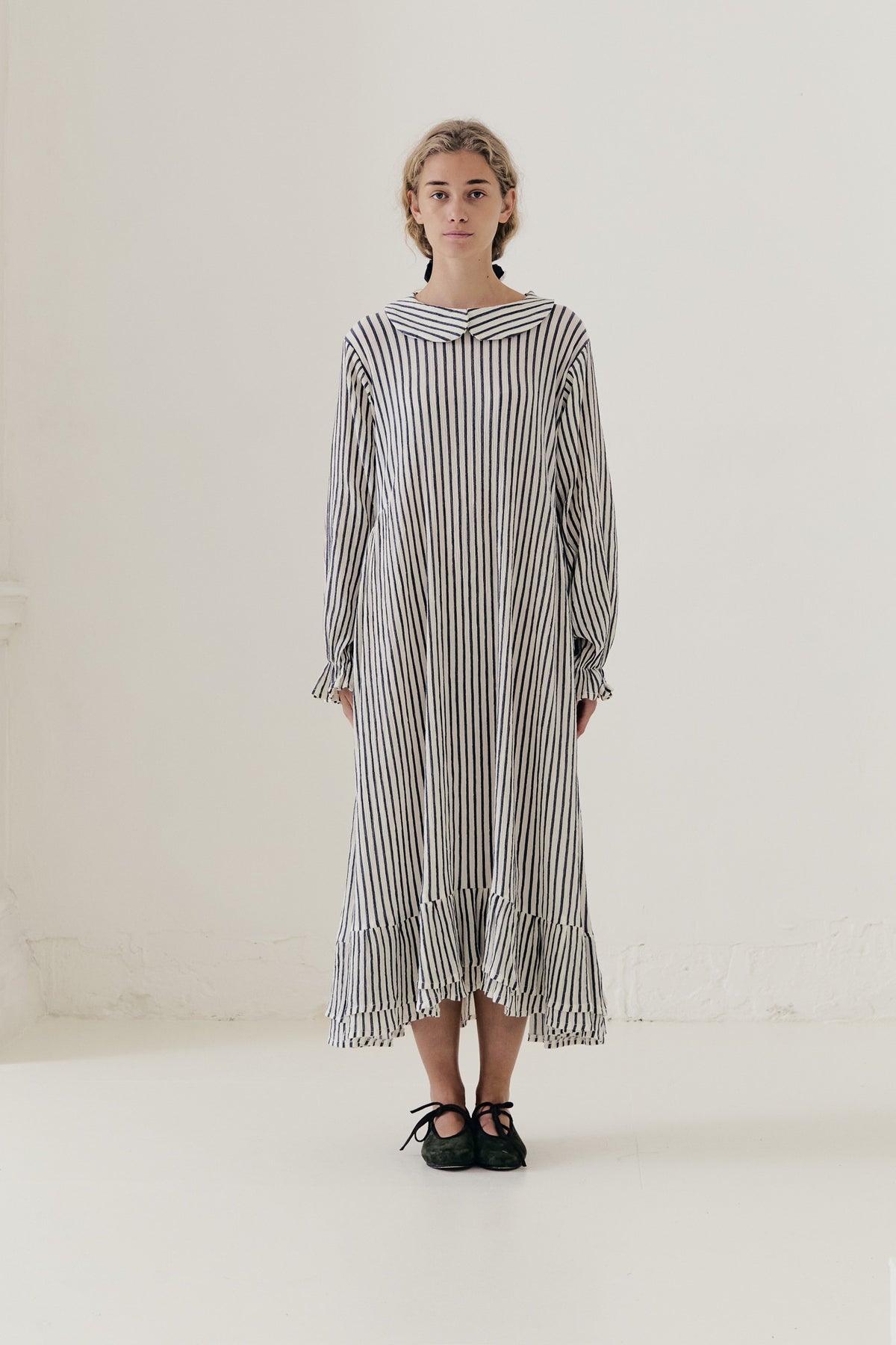 Bright, sunlit editorial lookbook capture of the striped Sillage dress, floating gracefully with an effortless sense of lightness.