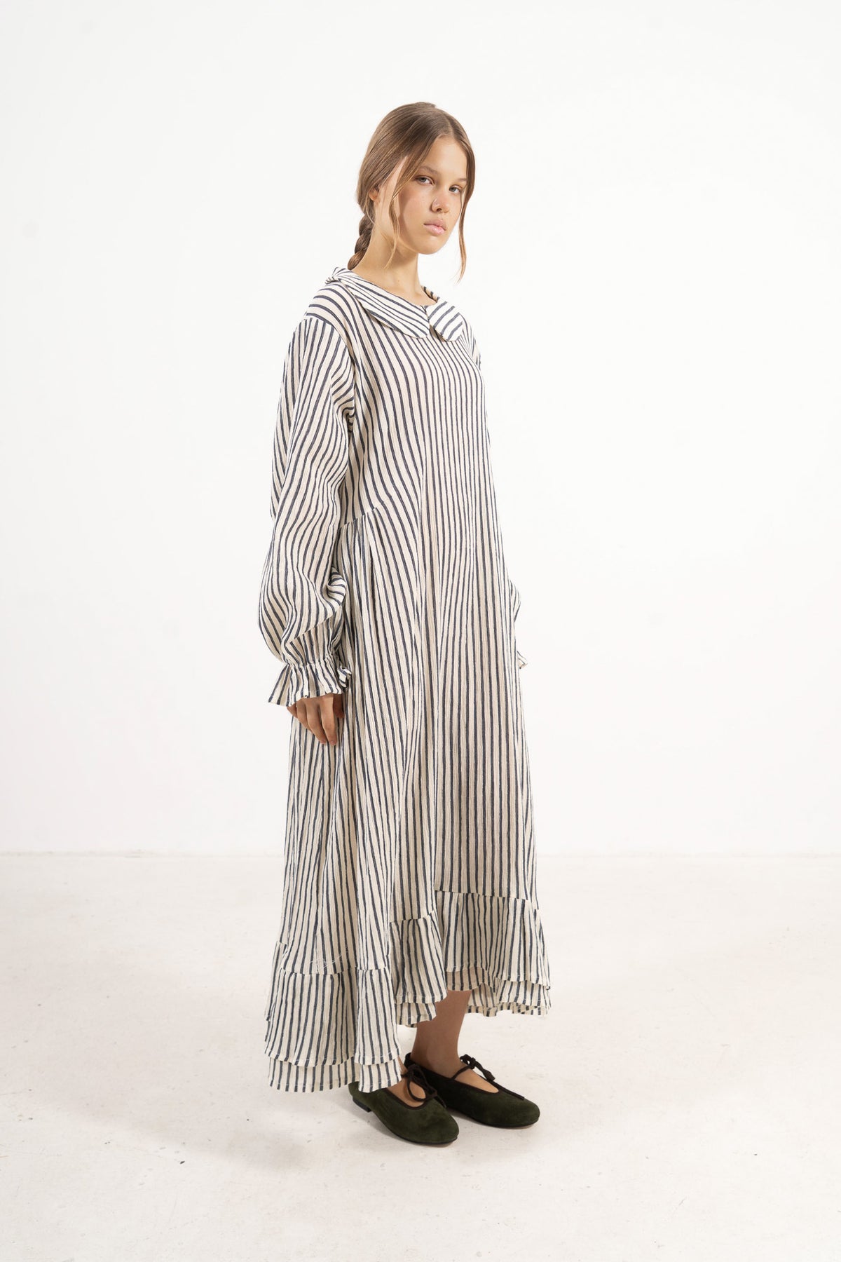 Side lookbook capture of the striped cotton dress, emphasizing how the flowing fabric moves easily with every step.